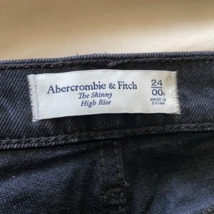 Skinny high rise black jeans with buttons